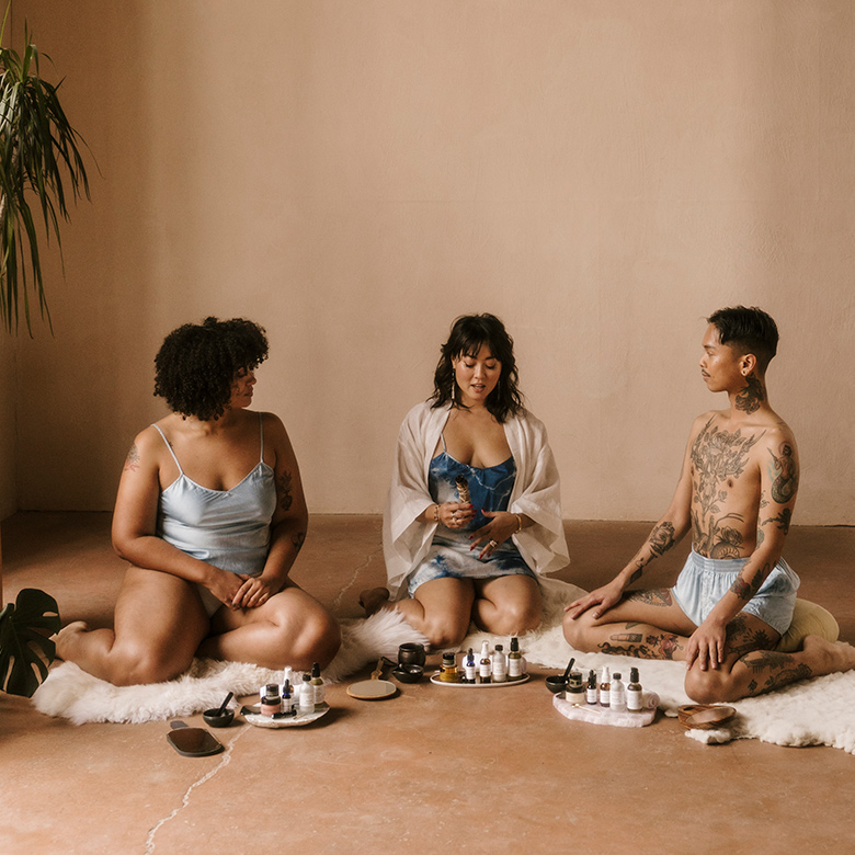 group of individuals sitting on floor doing skincare ritual