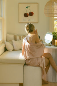 woman in draping robe doing luxury skincare routine